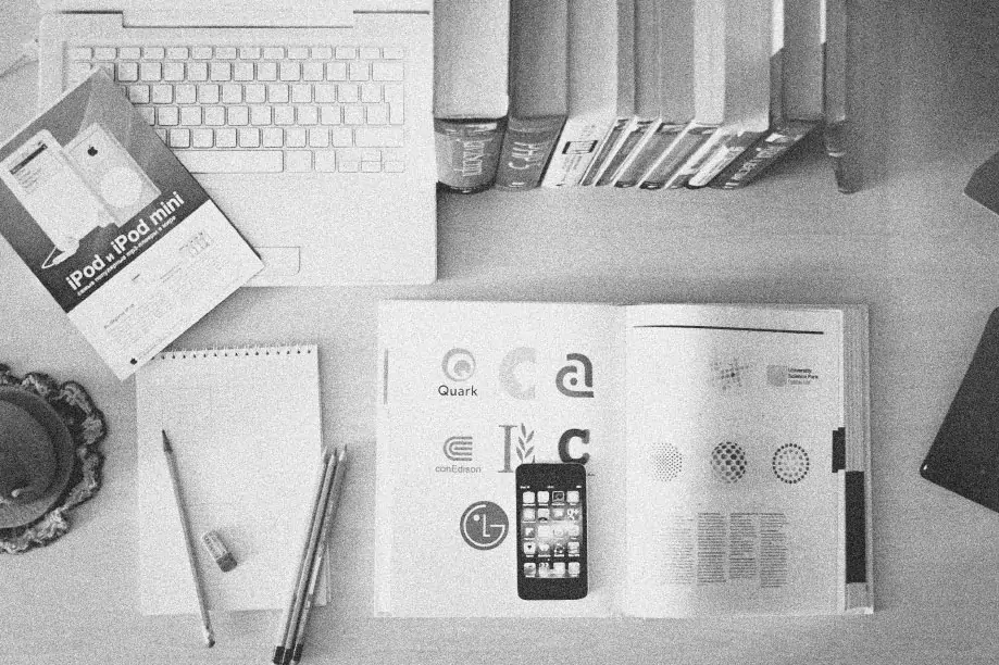 A desk full of textbooks about branding, marketing and advertising.